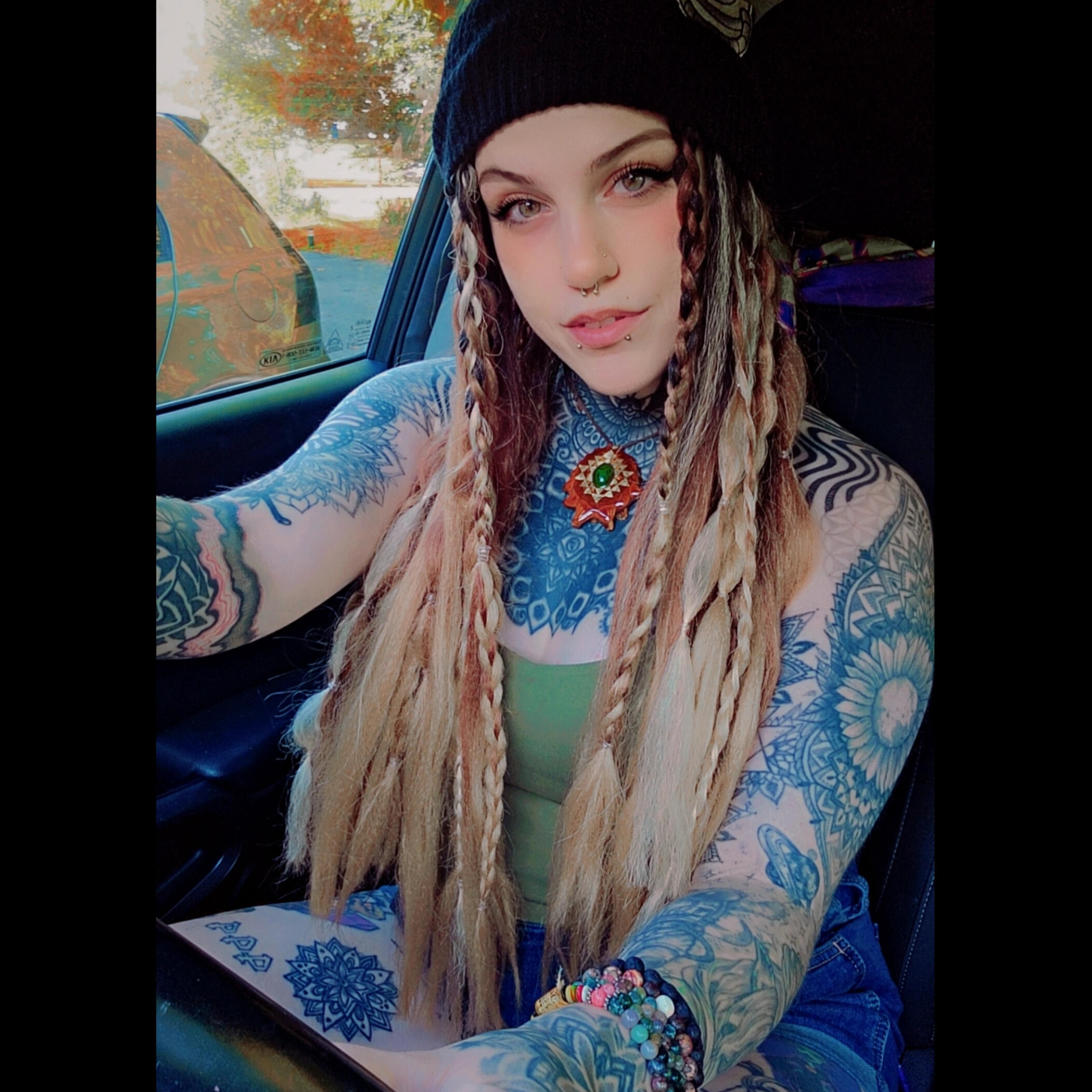 gorgeous tattooed model with long blonde hair, long blonde and brown dreadlocks and braids, beautiful tattoos, tattoo sleeves, tattooed model, alt girl, goth girl, milf, green halter top, large breasts, thigh tattoos, hippie girl, baddie